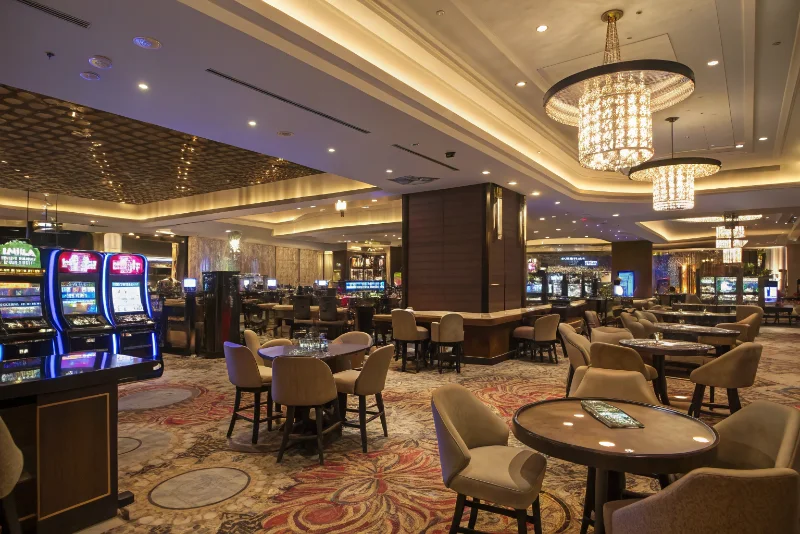 Modern casino interior showing spatial zones with varied lighting and furniture arrangements